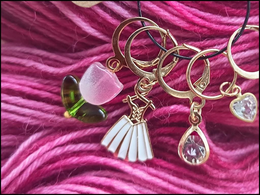 Stitch marker set with flowers, dress, pearl and drop pendant for knitting and crochet projects.