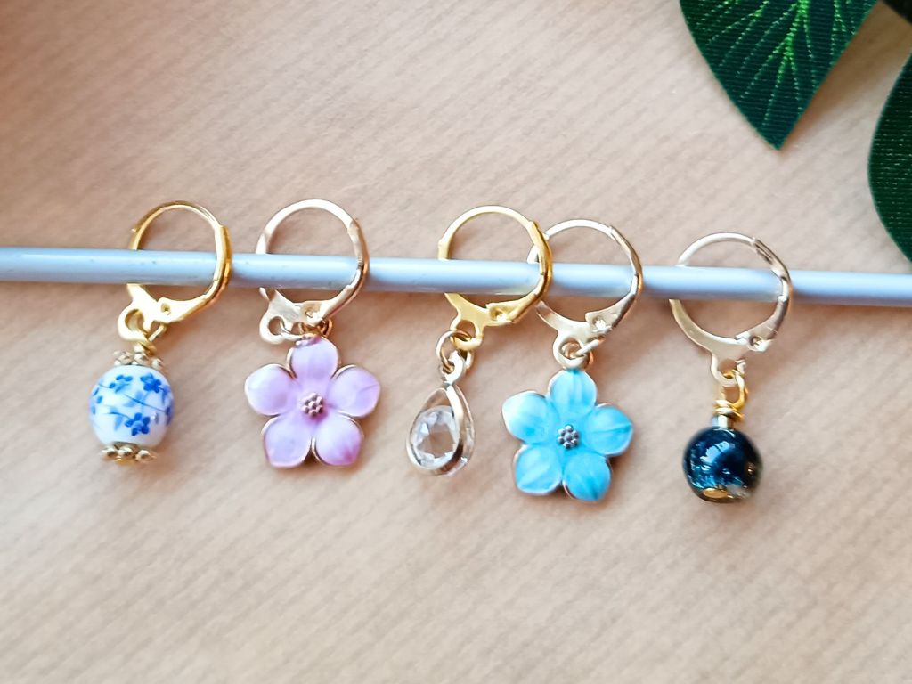 Stitch marker set with flowers and beads for knitting and crochet projects.