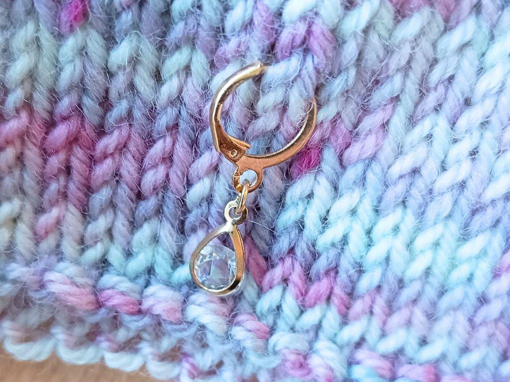 Stitch marker set with pendants and beads for knitting and crochet projects.