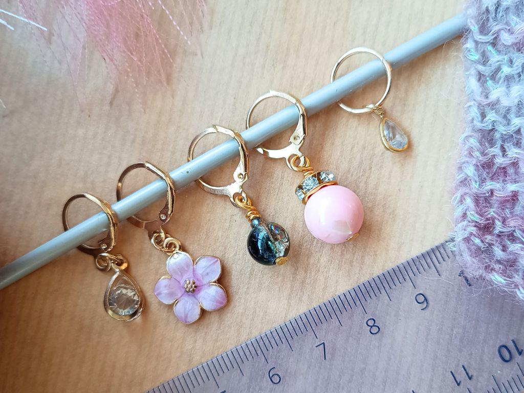 Stitch marker set with pendants and beads for knitting and crochet projects.