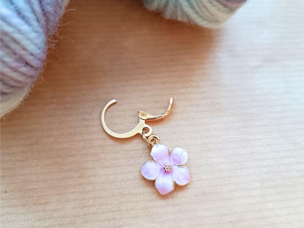 Stitch marker set with flowers and beads for knitting and crochet projects.
