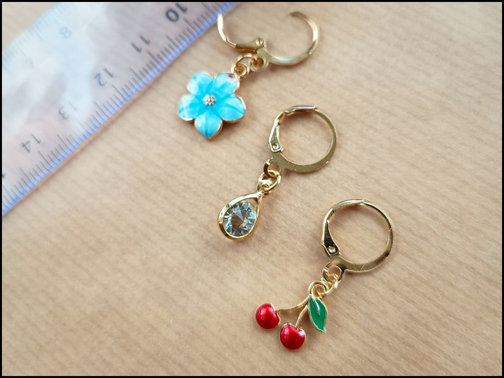 Stitch marker set with cherry, bee, star and flower for knitting and crochet projects. 