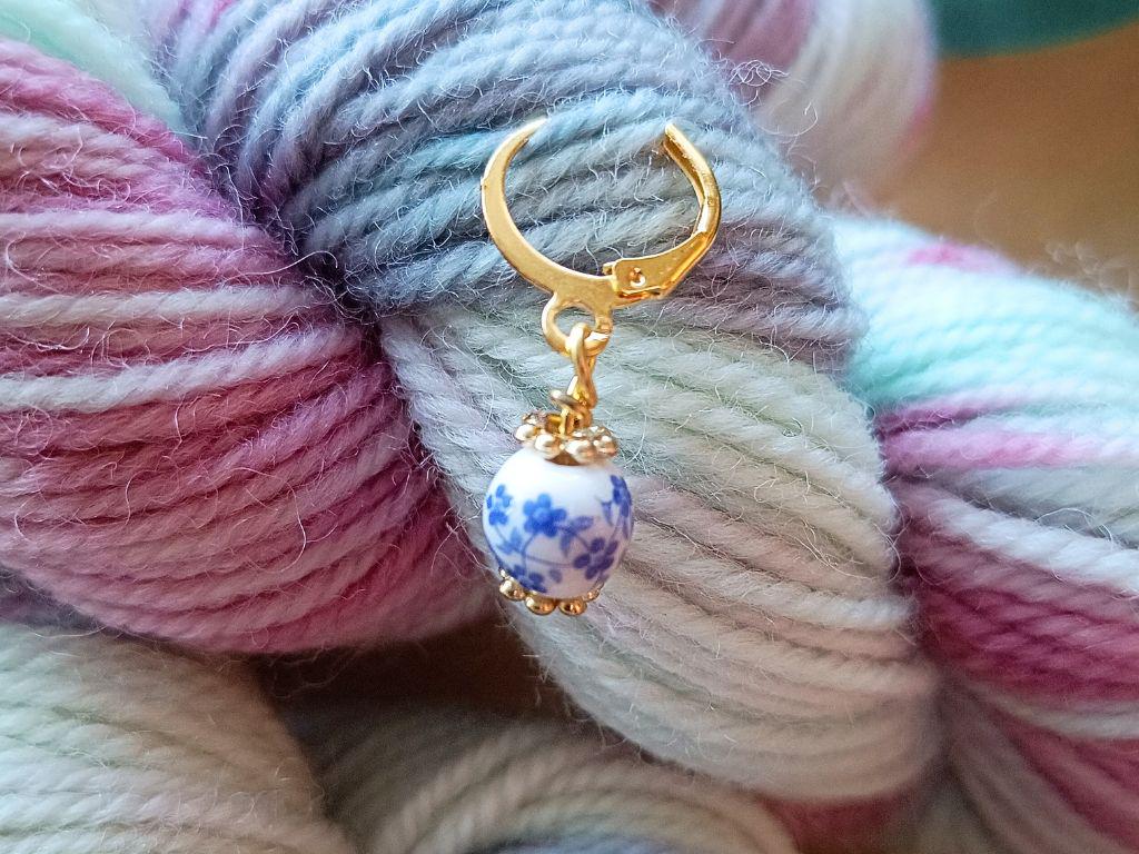 Stitch marker set with flowers and beads for knitting and crochet projects.