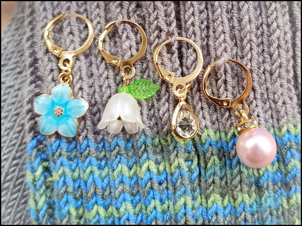 Stitch marker set with flowers, ladybug, pearl and drop pendant for knitting and crochet projects. 