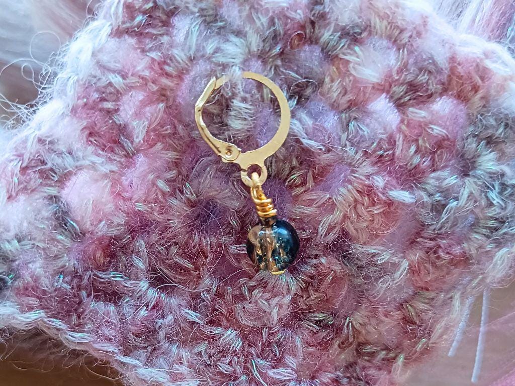 Stitch marker set with pendants and beads for knitting and crochet projects.