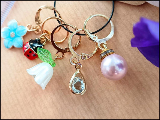 Stitch marker set with flowers, ladybug, pearl and drop pendant for knitting and crochet projects. 