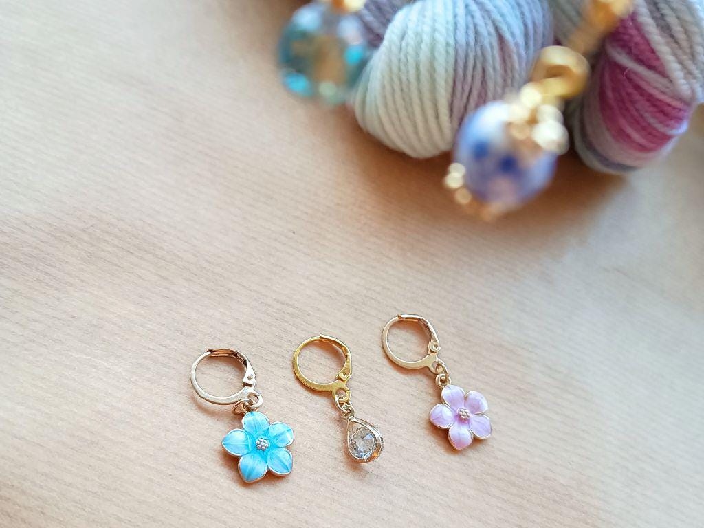 Stitch marker set with flowers and beads for knitting and crochet projects.