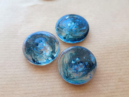 Handmade buttons for sewing, knitting or crocheting projects. Set of 4 buttons. Approx. 25 mm in diameter. Navy blue with glitter.