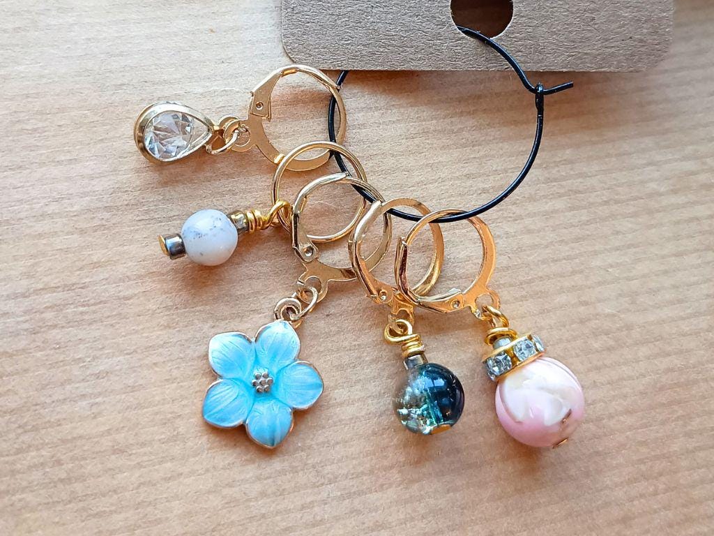 Stitch marker set with pendants and beads for knitting and crochet projects.