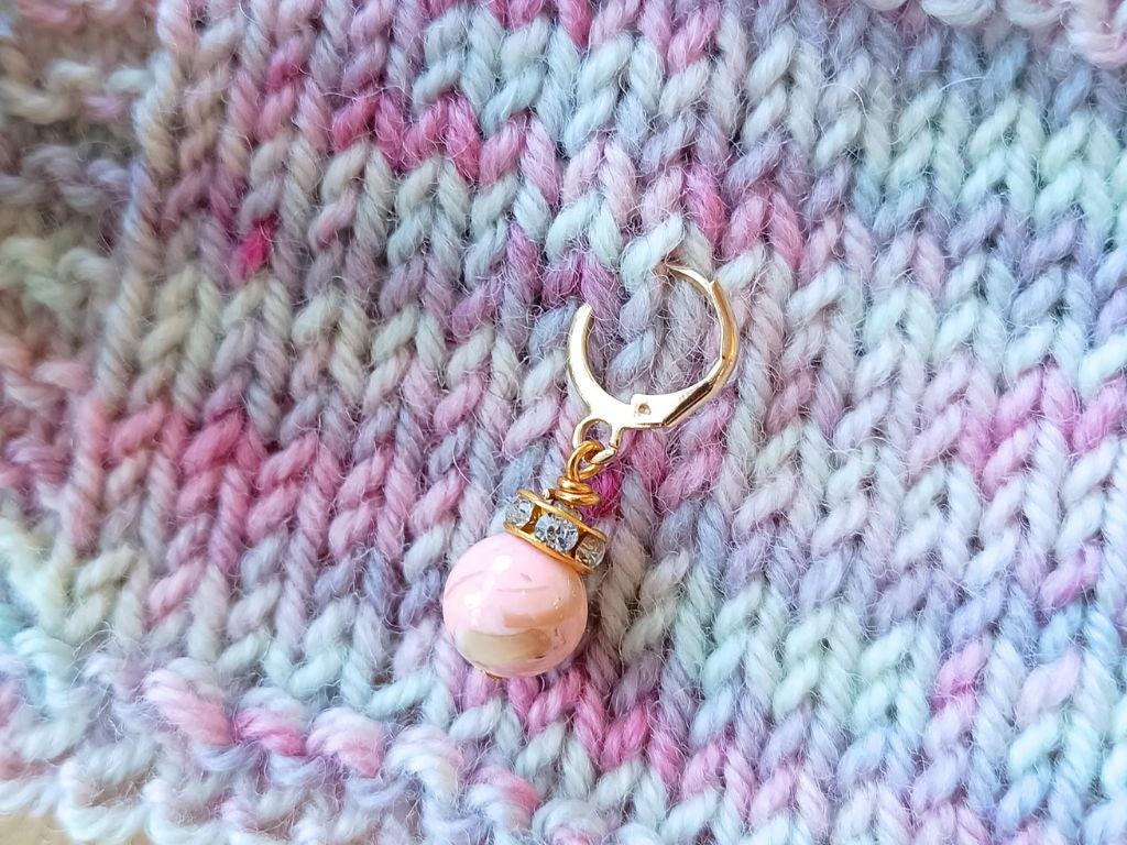 Stitch marker set with pendants and beads for knitting and crochet projects.