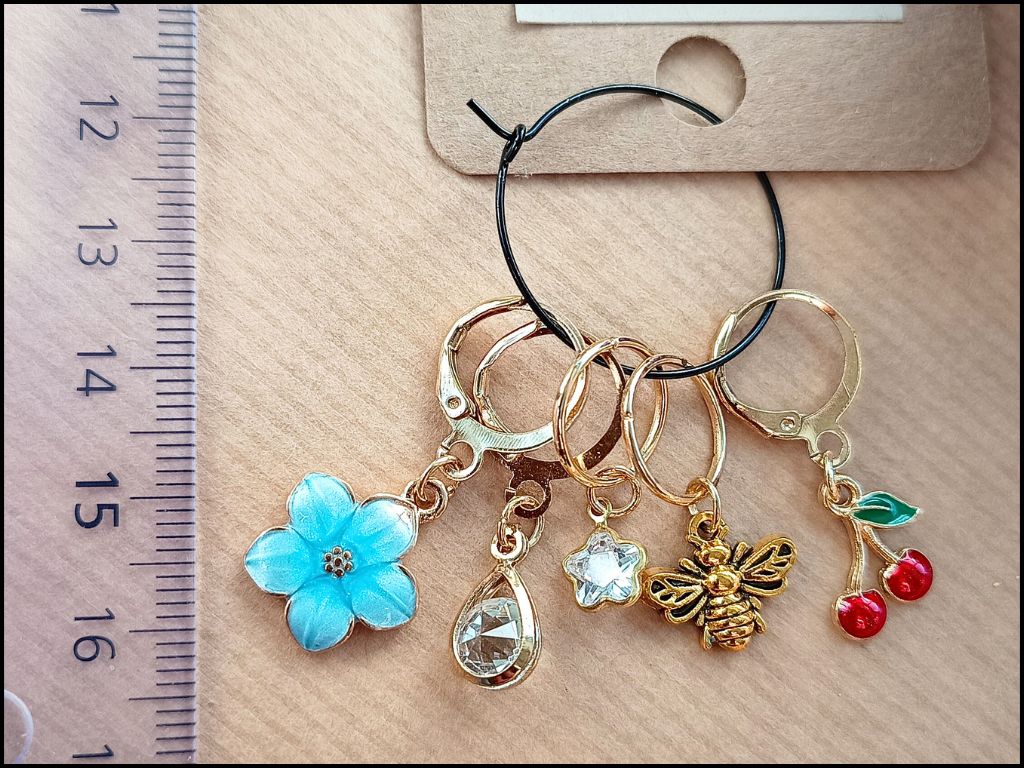 Stitch marker set with cherry, bee, star and flower for knitting and crochet projects. 
