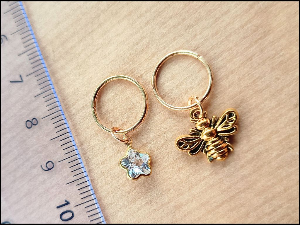 Stitch marker set with cherry, bee, star and flower for knitting and crochet projects. 
