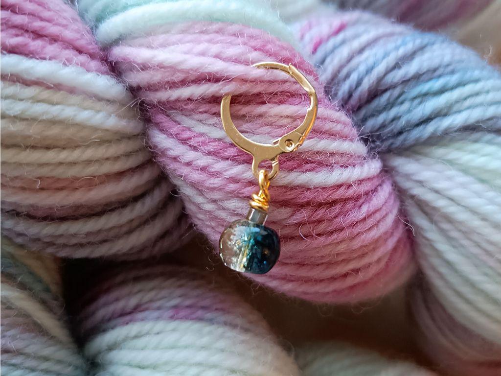 Stitch marker set with flowers and beads for knitting and crochet projects.