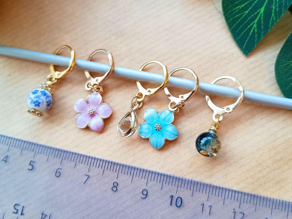 Stitch marker set with flowers and beads for knitting and crochet projects.