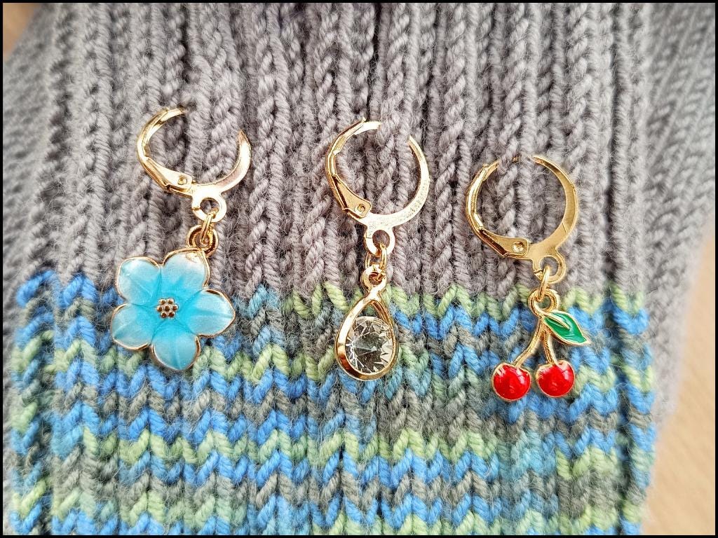 Stitch marker set with cherry, bee, star and flower for knitting and crochet projects. 