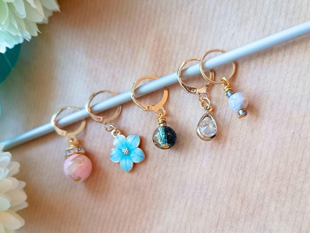 Stitch marker set with pendants and beads for knitting and crochet projects.