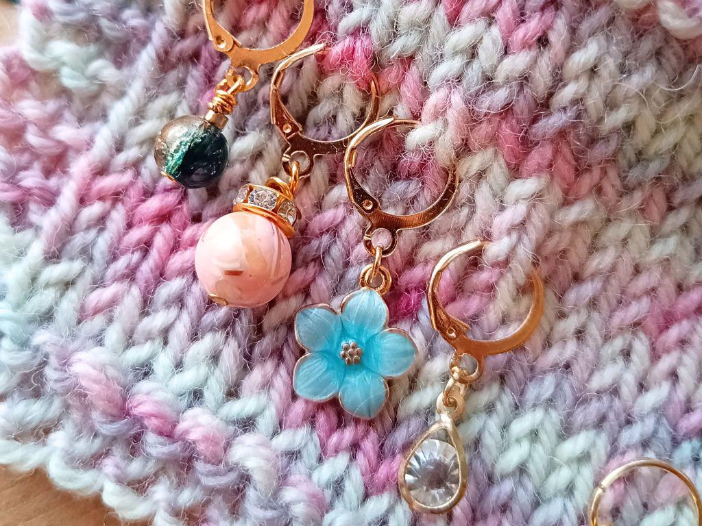 Stitch marker set with pendants and beads for knitting and crochet projects.