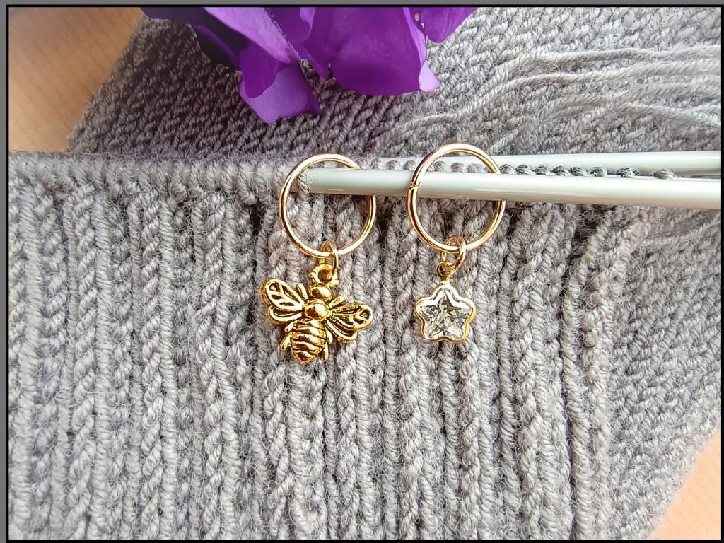 Stitch marker set with cherry, bee, star and flower for knitting and crochet projects. 