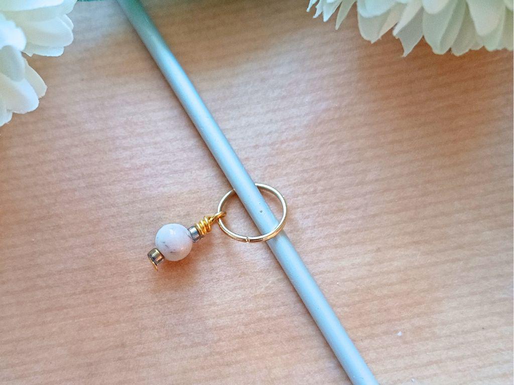 Stitch marker set with pendants and beads for knitting and crochet projects.