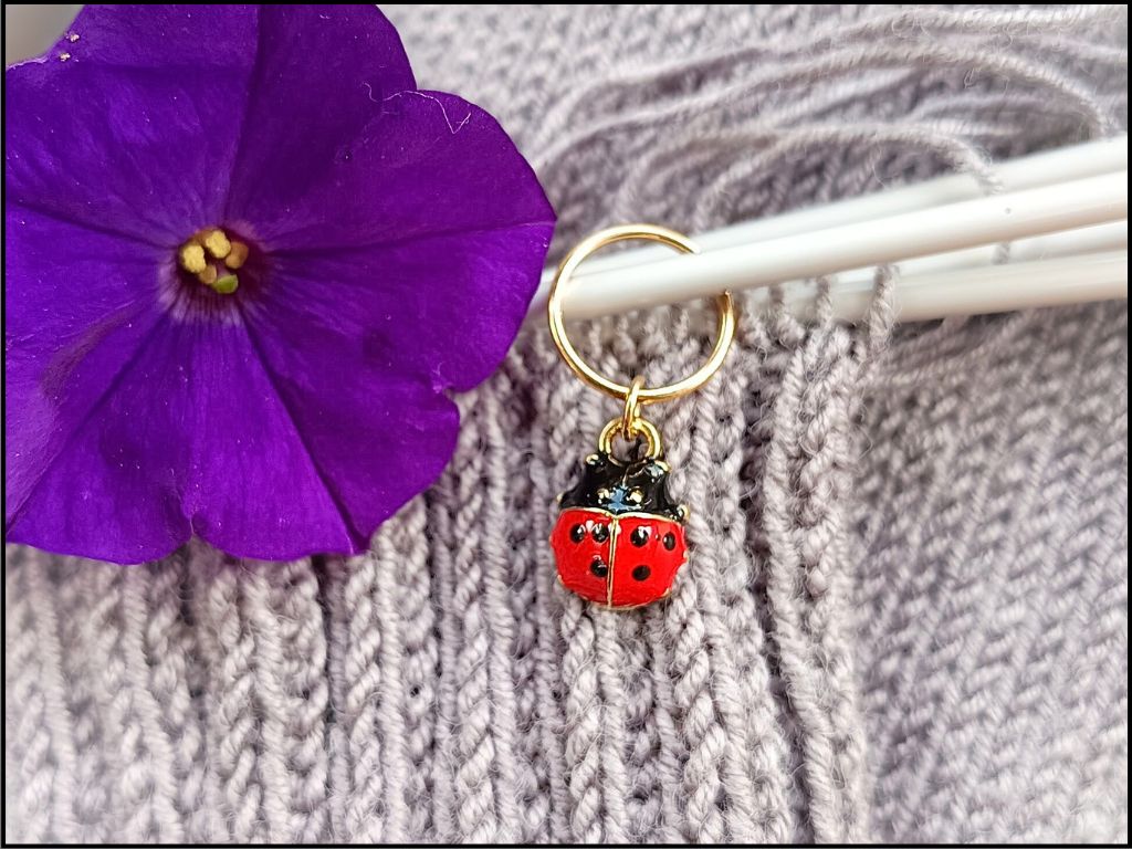 Stitch marker set with flowers, ladybug, pearl and drop pendant for knitting and crochet projects. 